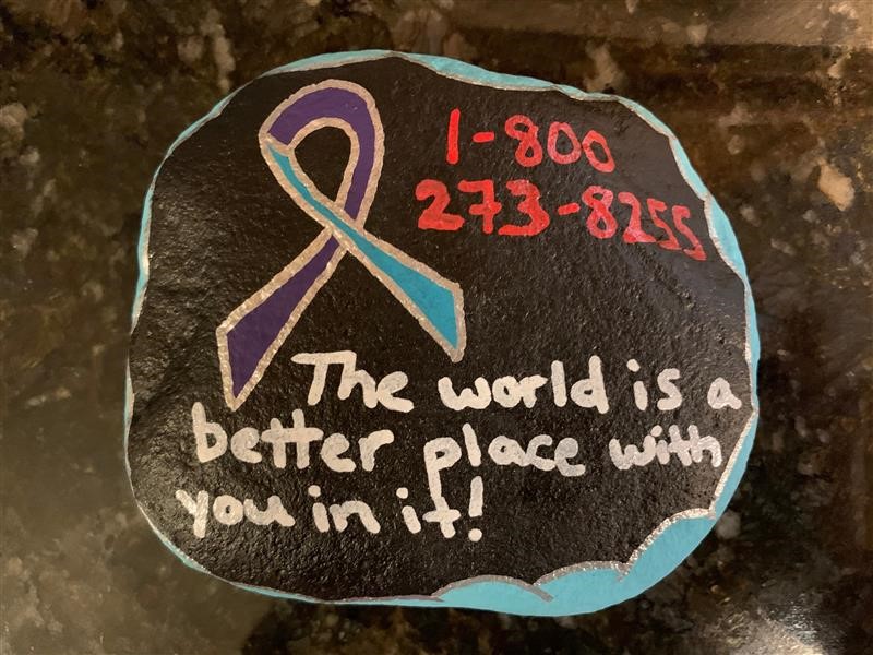 rock that says "the world is better with you in it"